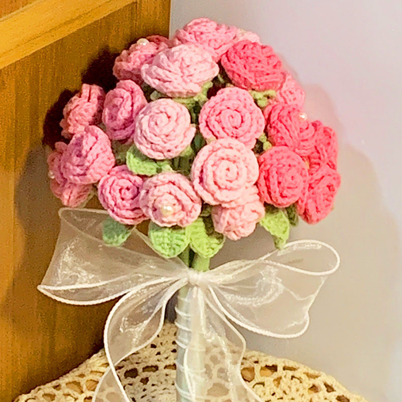 Waterfall bride holds a knitted bouquet of flowers to knit wedding gifts