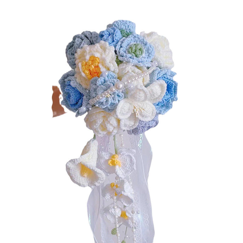 Waterfall bride holds a knitted bouquet of flowers to knit wedding gifts
