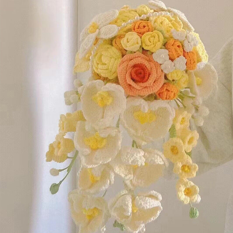 Waterfall bride holds a knitted bouquet of flowers to knit wedding gifts