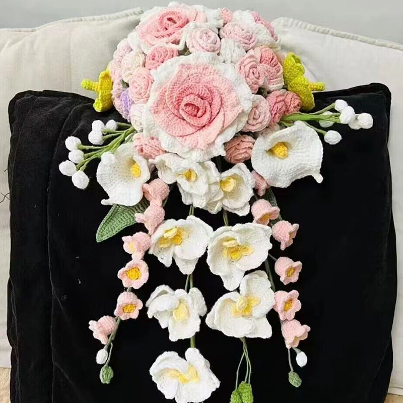 Waterfall bride holds a knitted bouquet of flowers to knit wedding gifts